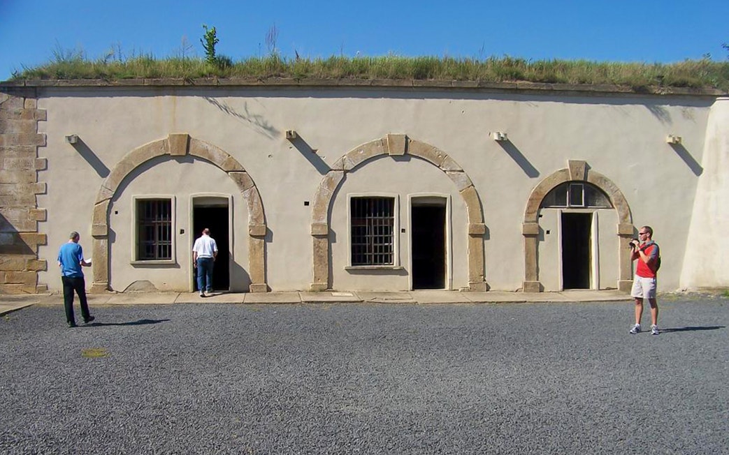 Visitors exploring the courtyard of Terezin Concentration Camp.
