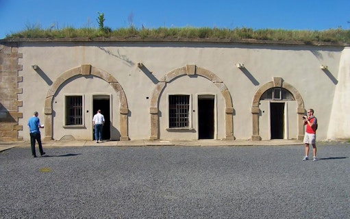 Visitors exploring the courtyard of Terezin Concentration Camp.