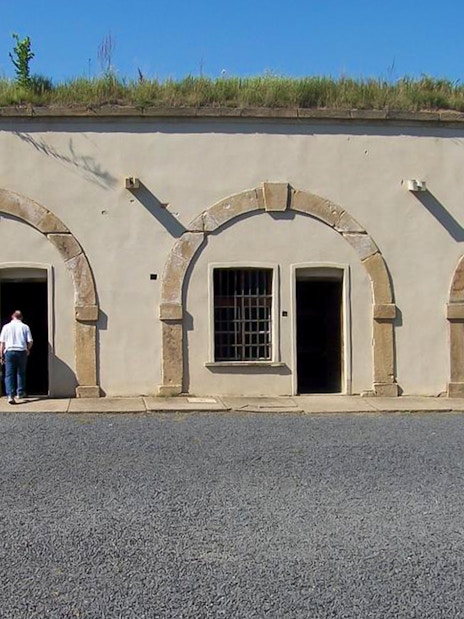 Visitors exploring the courtyard of Terezin Concentration Camp.