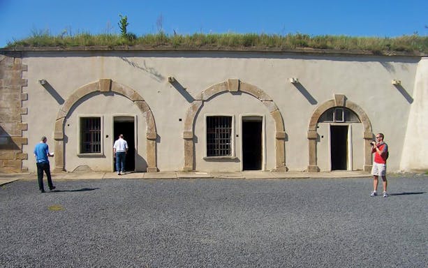 Visitors exploring the courtyard of Terezin Concentration Camp.