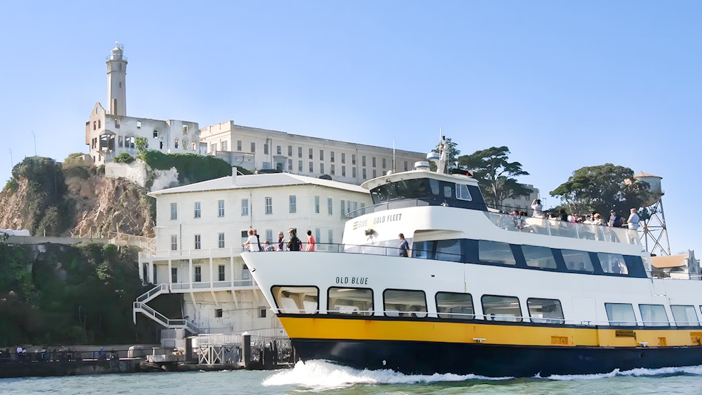 Guests viewing Alcatraz Island from a boat during San Francisco Bay Cruise.