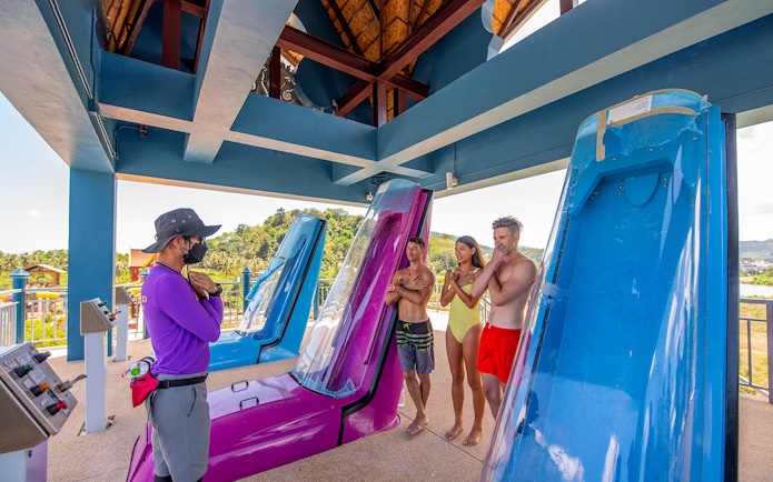 Staff instructing visitors on safety for Naga Jungle slide at Andamanda Phuket.
