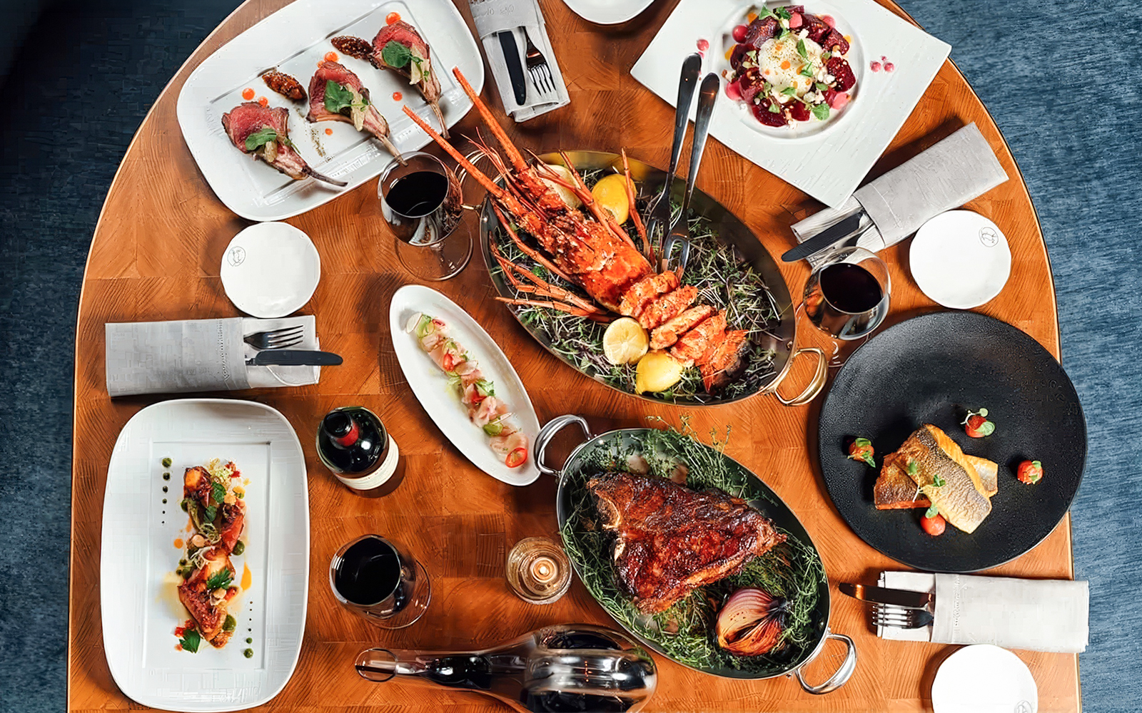 Dinner spread at Baha Mar Resort in Nassau, Bahamas featuring lobster, steak, and gourmet dishes.