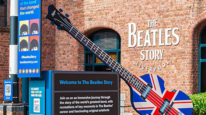 Exteriors of The Beatles Story museum in Liverpool with Union Jack guitar display.