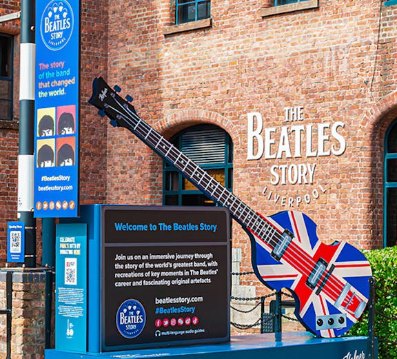 Exteriors of The Beatles Story museum in Liverpool with Union Jack guitar display.