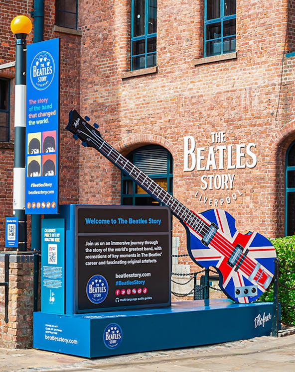 Exteriors of The Beatles Story museum in Liverpool with Union Jack guitar display.