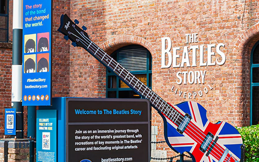 Exteriors of The Beatles Story museum in Liverpool with Union Jack guitar display.