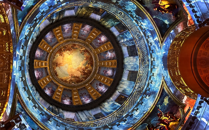 Dome interior with vibrant frescoes at Invalides Aura Immersive Experience, Paris.