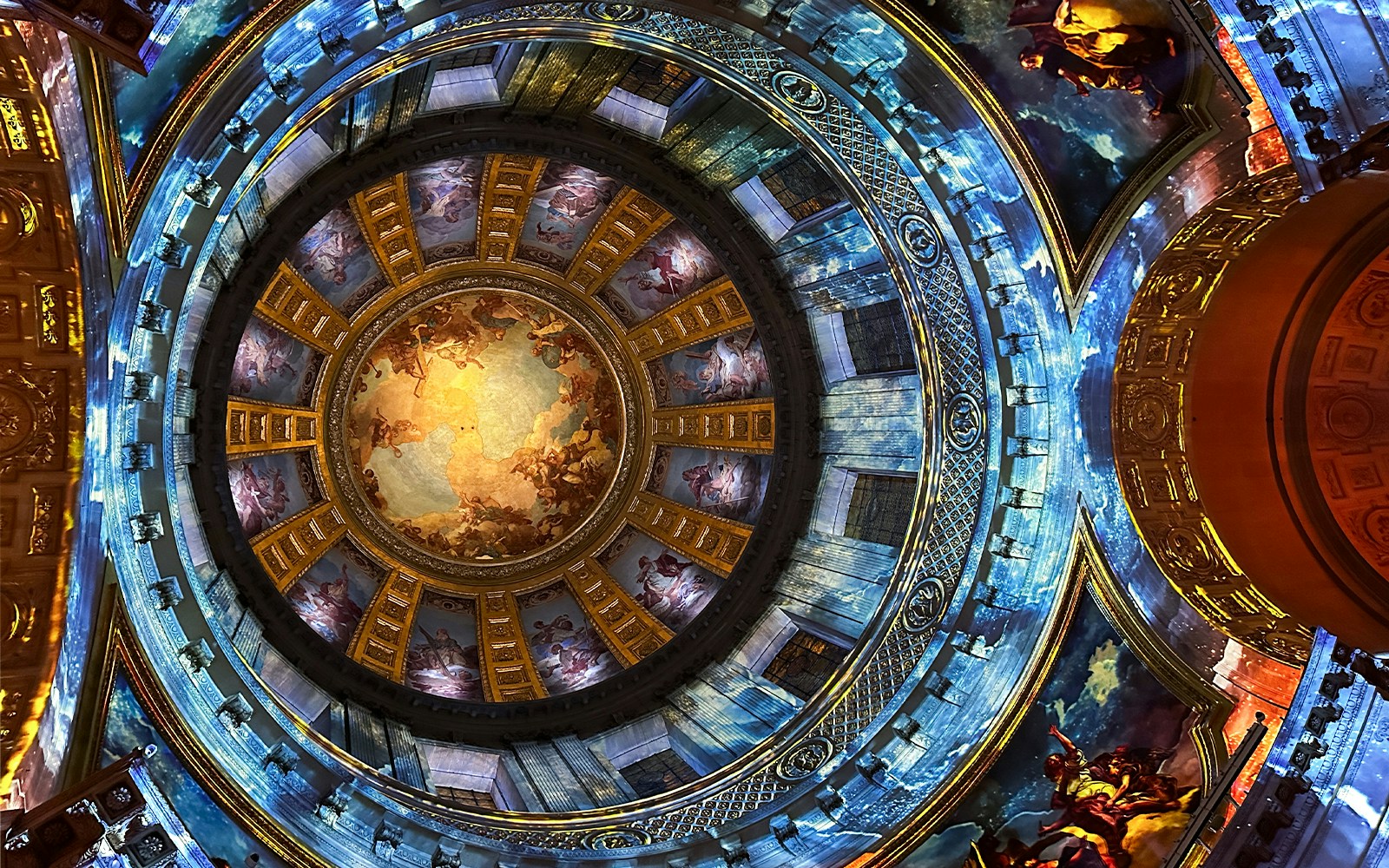Dome interior with vibrant frescoes at Invalides Aura Immersive Experience, Paris.