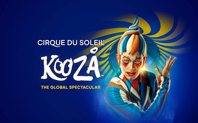 Cirque du Soleil Kooza performer in colorful costume with vibrant background.