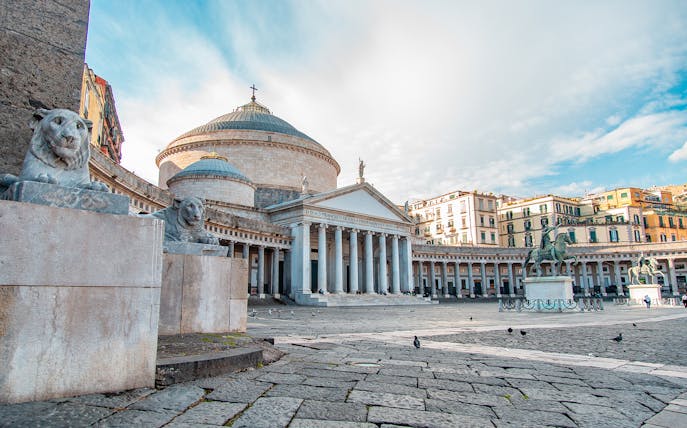 Piazza del Plebiscito in Naples with San Francesco di Paola Basilica and lion statues.