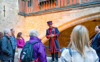 Beefeater guiding a group during the VIP Tower of London after-hours tour.