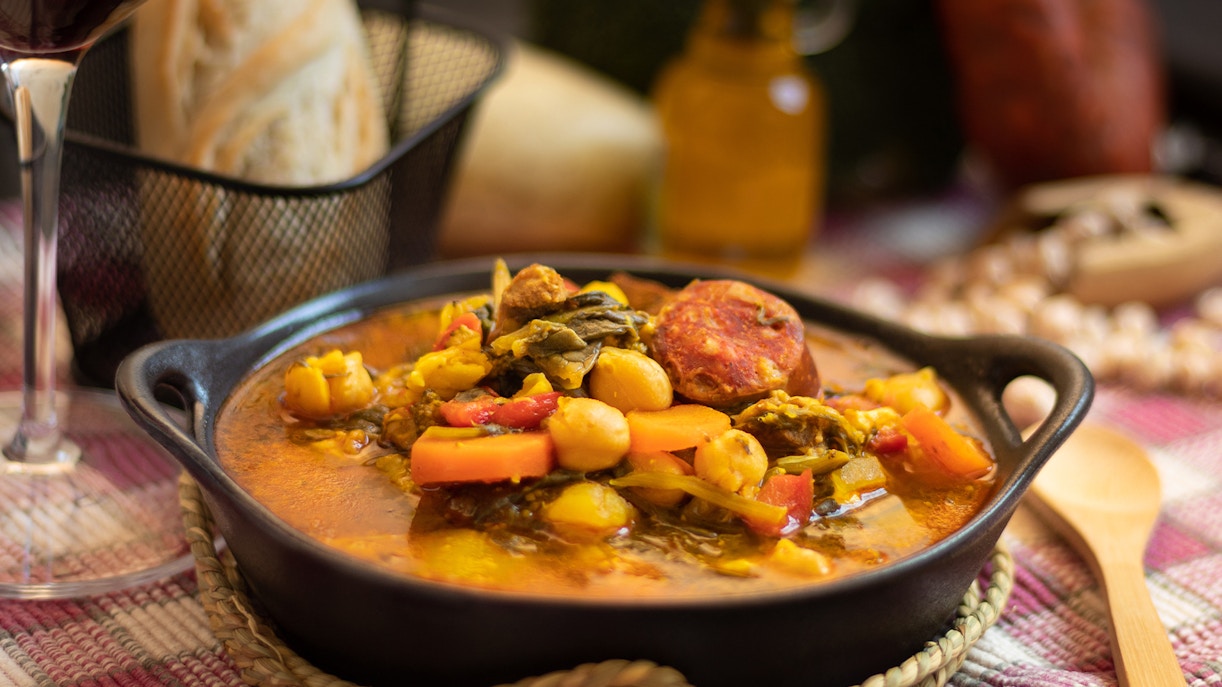 Hot chickpea and spinach stew in a black bowl, Avila, Castilian cuisine.