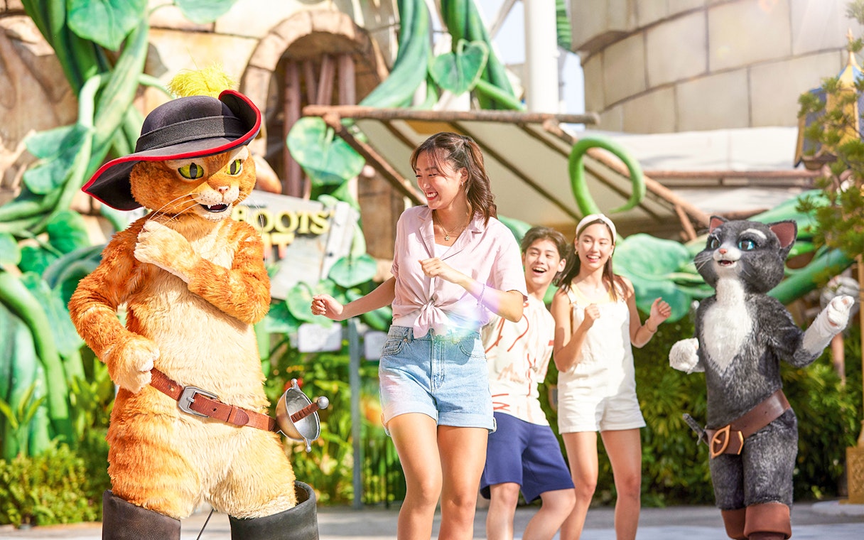 Visitors interacting with Puss in Boots characters at Universal Studios Singapore.