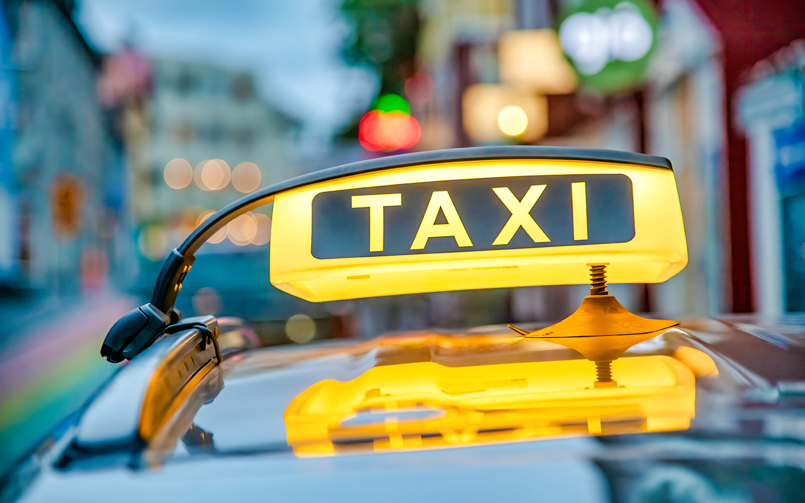 Yellow taxi sign on a car roof in Reykjavik, Iceland.