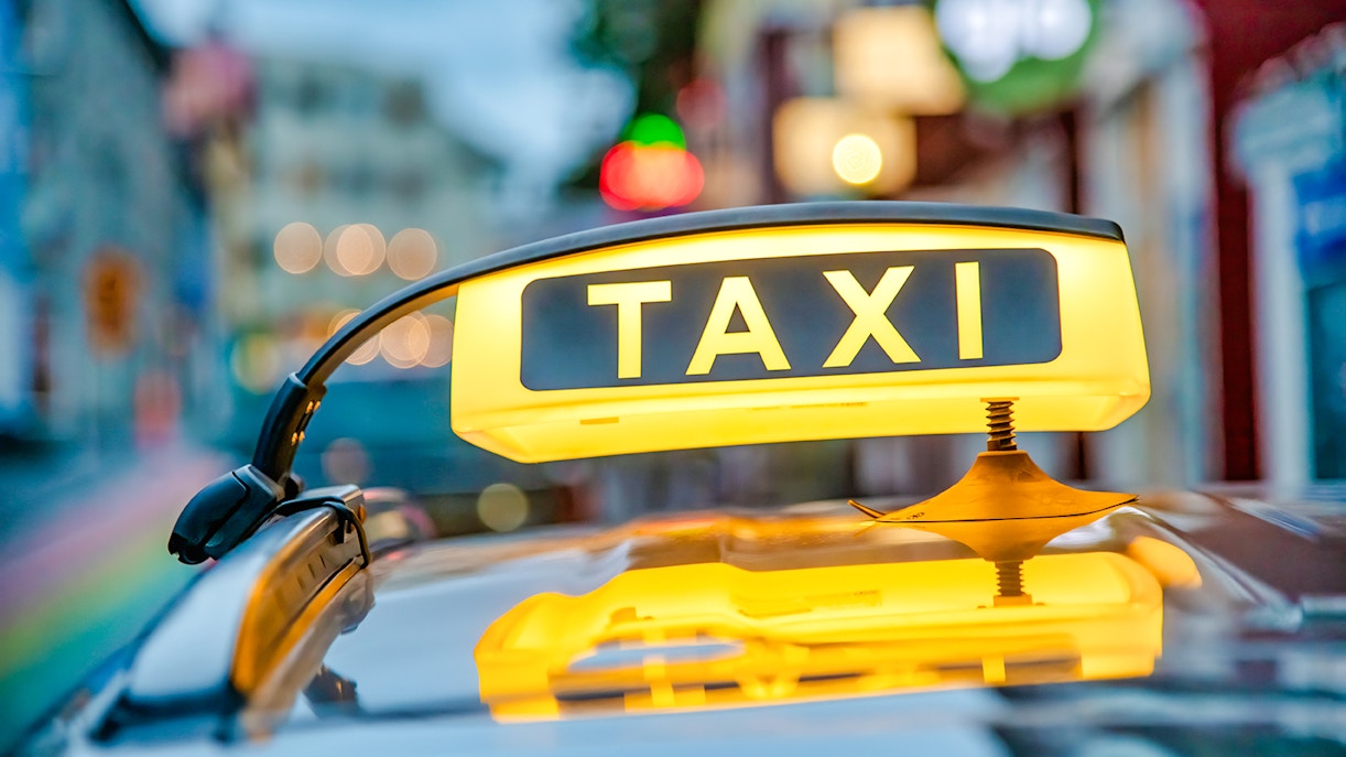 Yellow taxi sign on a car roof in Reykjavik, Iceland.