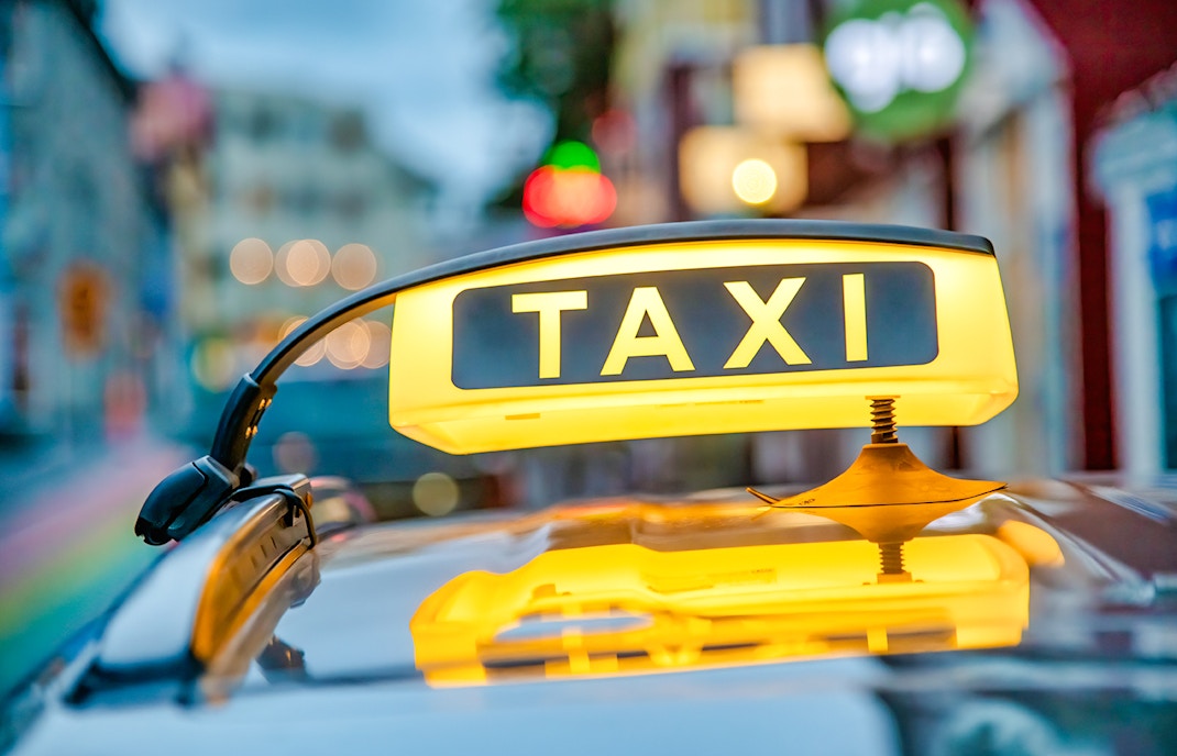 Yellow taxi sign on a car roof in Reykjavik, Iceland.