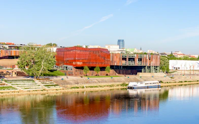 Copernicus Science Center in Warsaw with river view and modern architecture.