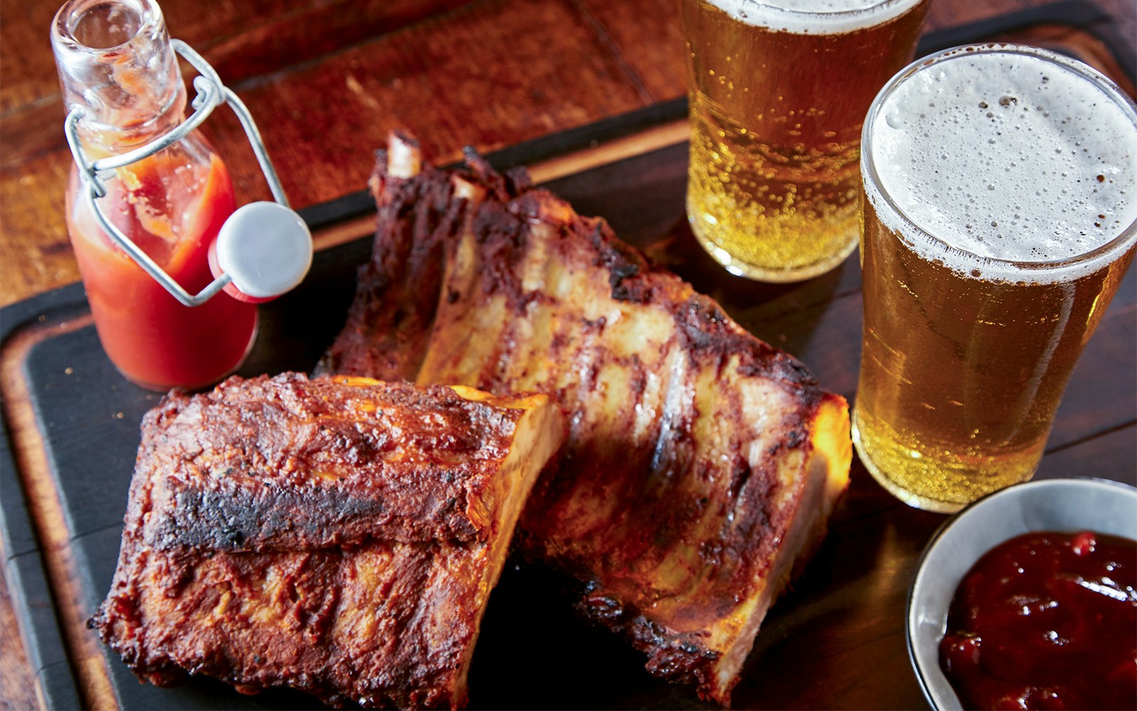 Barbecue ribs with sauce and beer at Disneyland Paris restaurant.