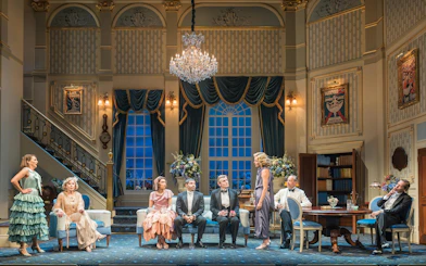 Cast of "HAY FEVER" performing on a West End stage with elegant set design.