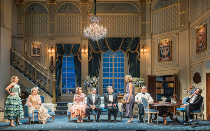 Cast of "HAY FEVER" performing on a West End stage with elegant set design.