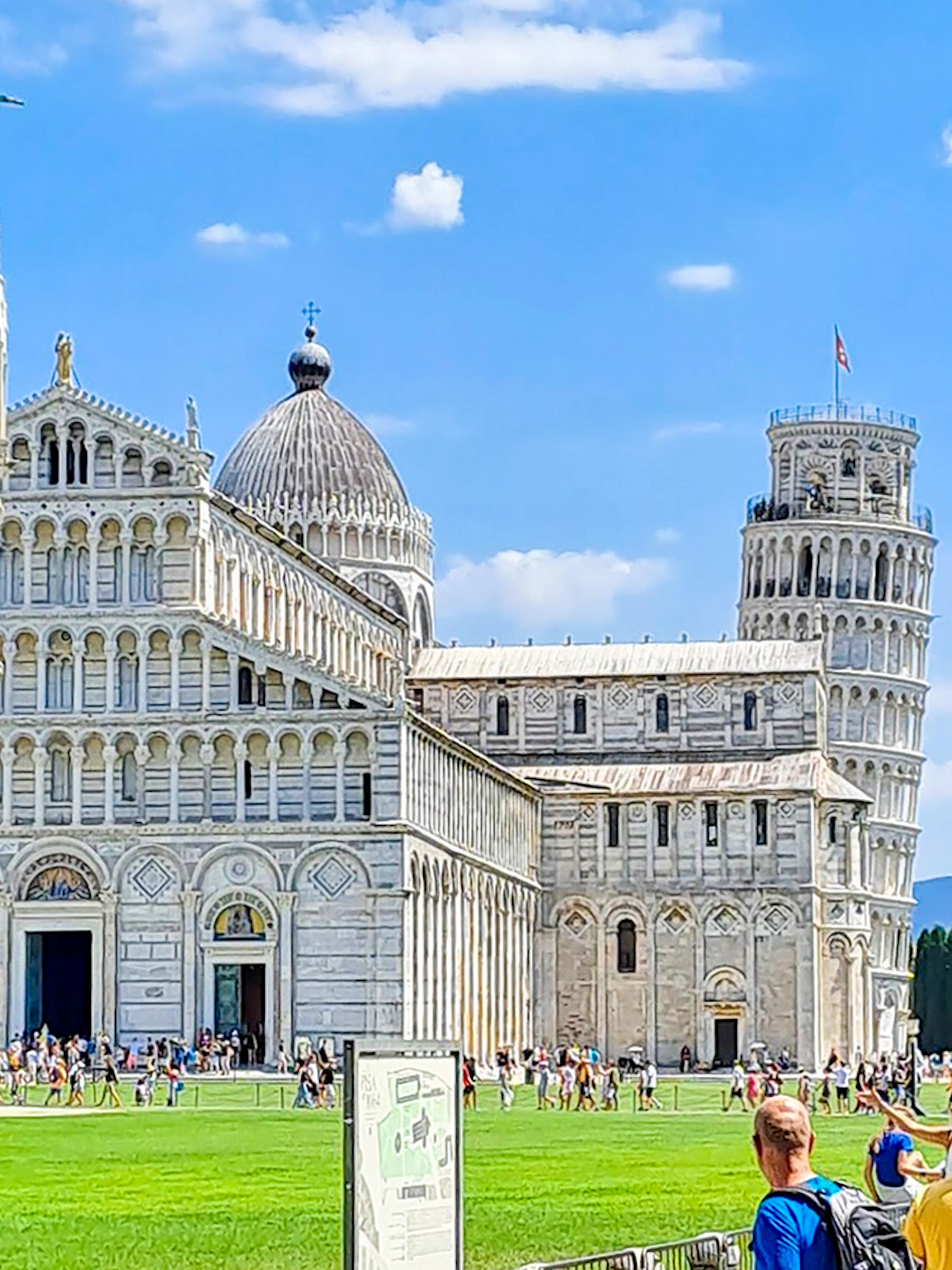 Pisa Cathedral and Leaning Tower viewed through an archway during a guided walking tour.