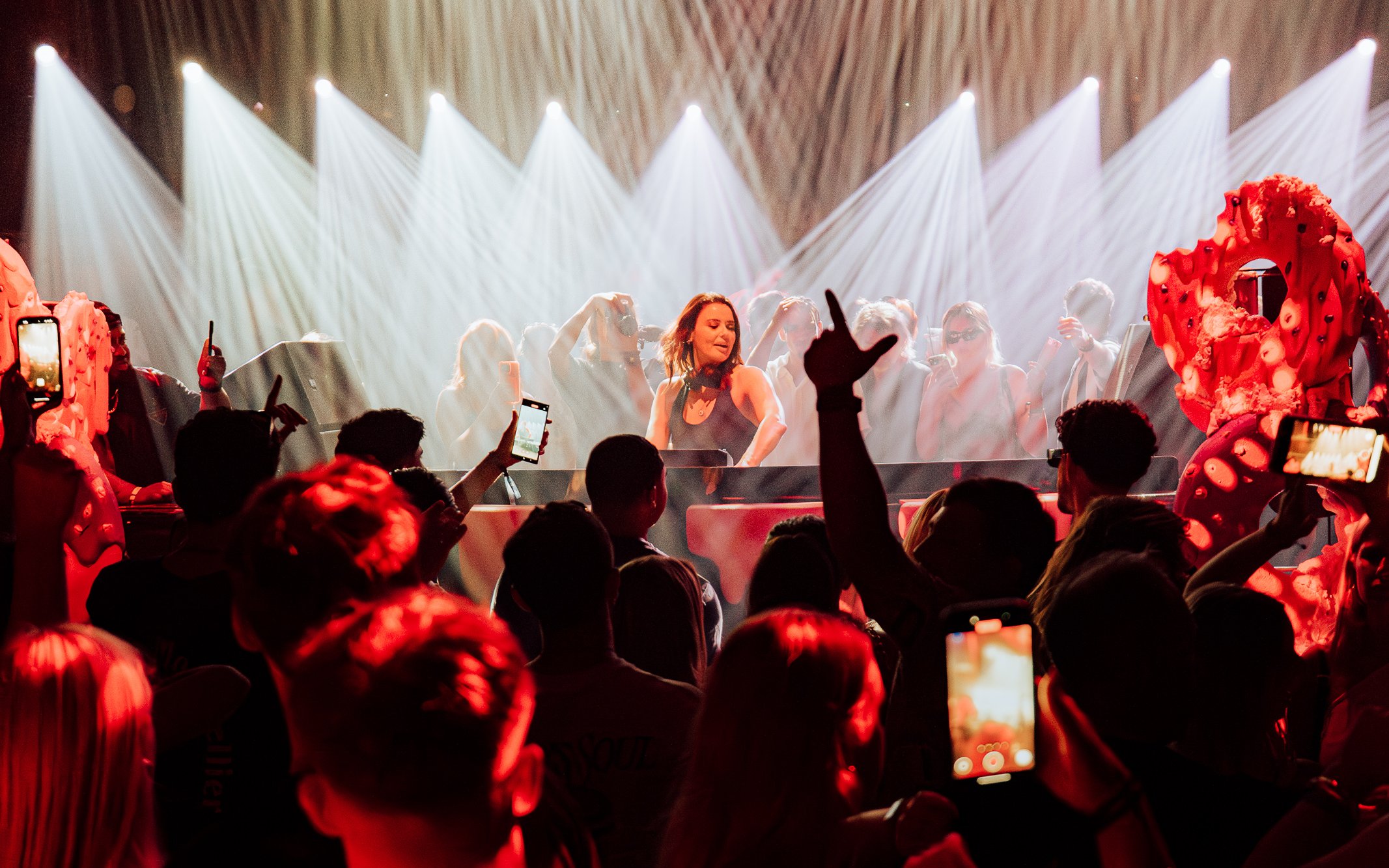 DJ performing at Club Chinois with crowd and lights, Ibiza.