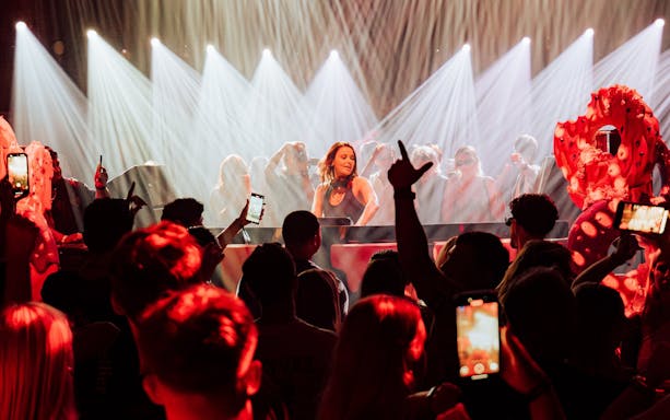 DJ performing at Club Chinois with crowd and lights, Ibiza.