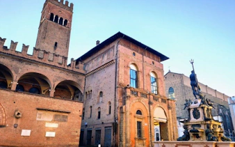 Bologna's Neptune Fountain and medieval architecture on self-guided murder mystery tour.