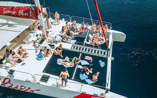 Group relaxing on a catamaran during a cruise to Hvar and Pakleni Islands.