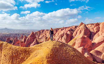 Girl overlooking Red Valley rock formations in Cappadocia, Turkey.