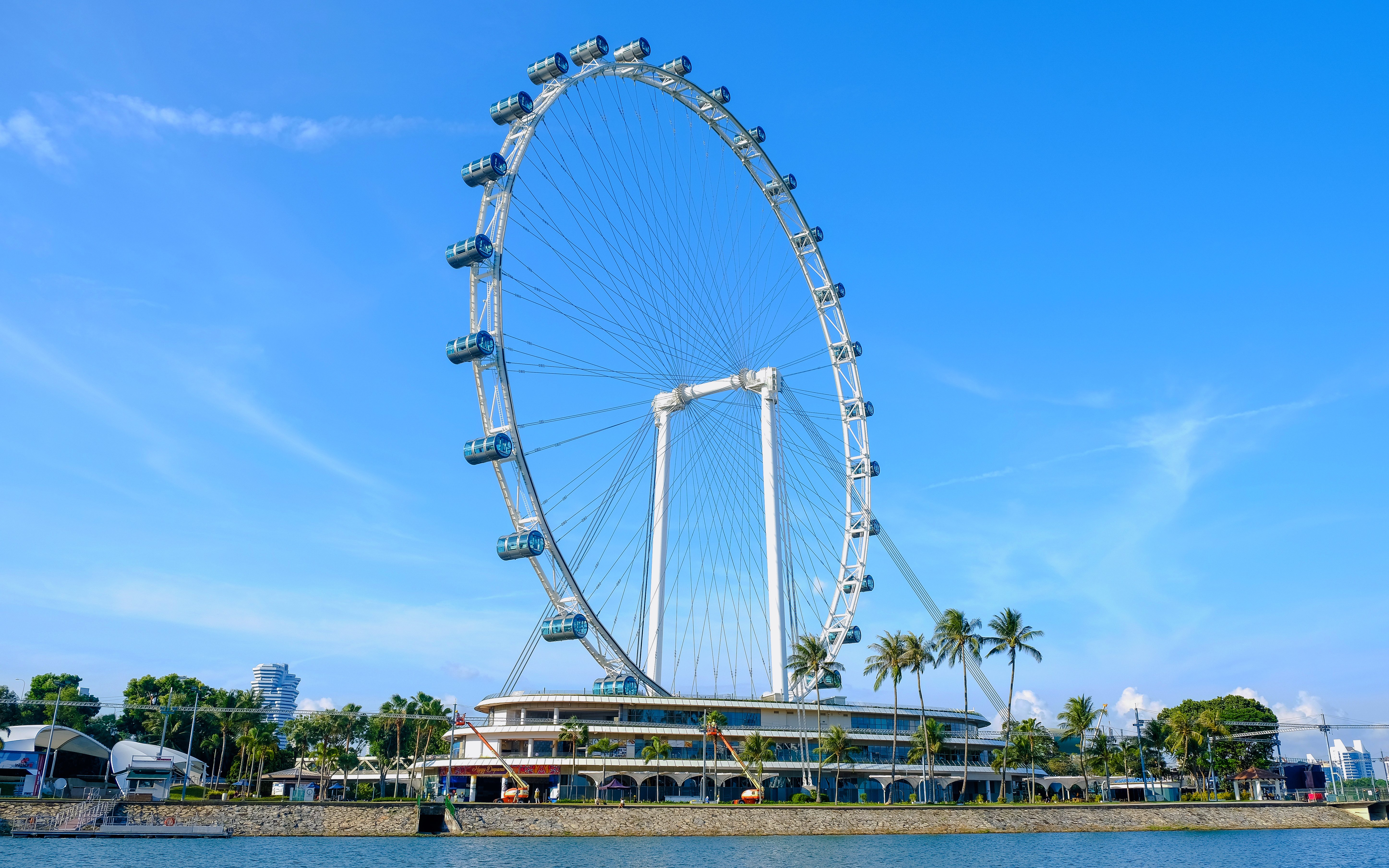 Singapore Flyer observation wheel against blue sky.