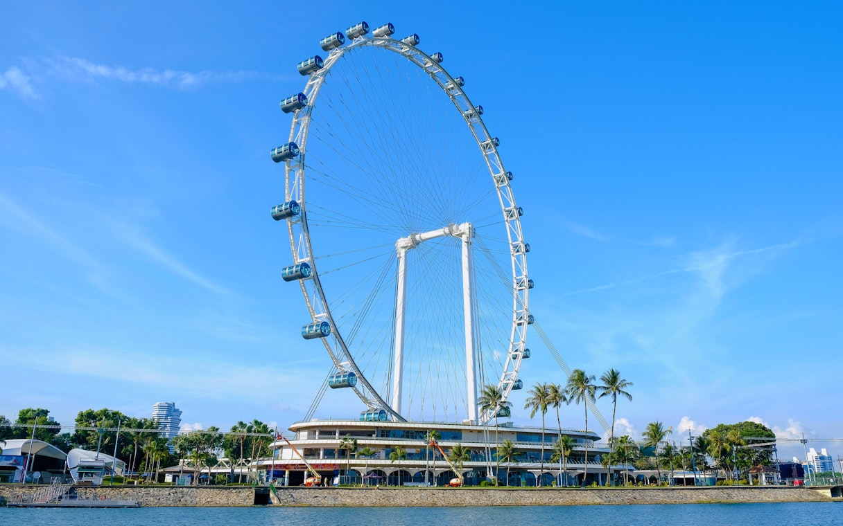 Singapore Flyer observation wheel against blue sky.