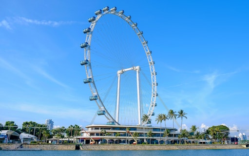 Singapore Flyer observation wheel against blue sky.