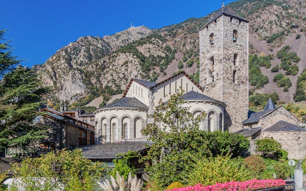 Romanesque church in Andorra with mountain backdrop on a full-day tour from Barcelona.