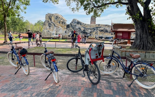 Bicycles parked near the Reclining Buddha statue in Ayutthaya, Thailand.