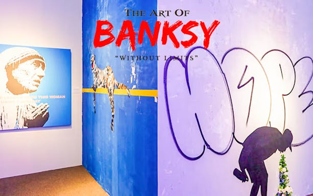 Banksy artwork at "Without Limits" exhibition in Singapore, featuring graffiti and stencil art.