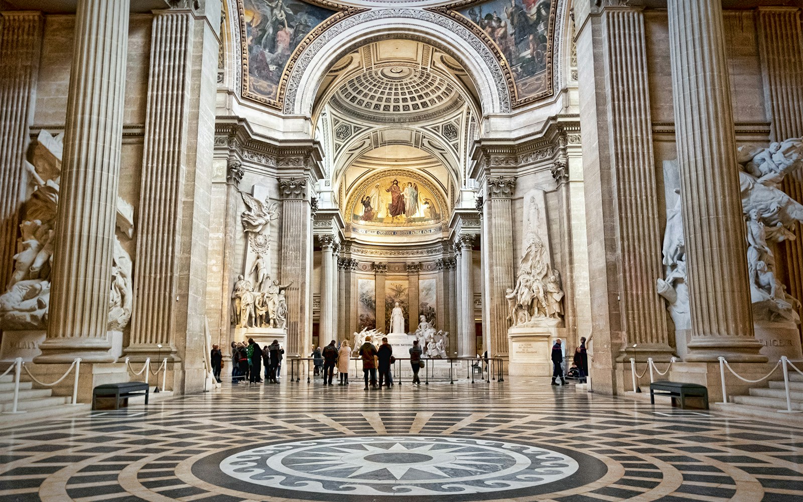 Interior of Paris Pantheon with ornate columns and sculptures.