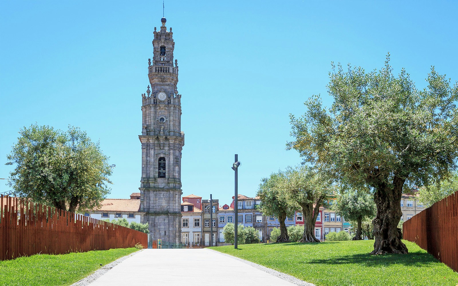 Clerigos Tower in Porto with surrounding trees and historic buildings.