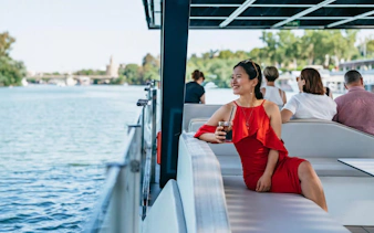 Tourist enjoying Eco-Friendly Guadalquivir River Cruise in Seville, Spain.