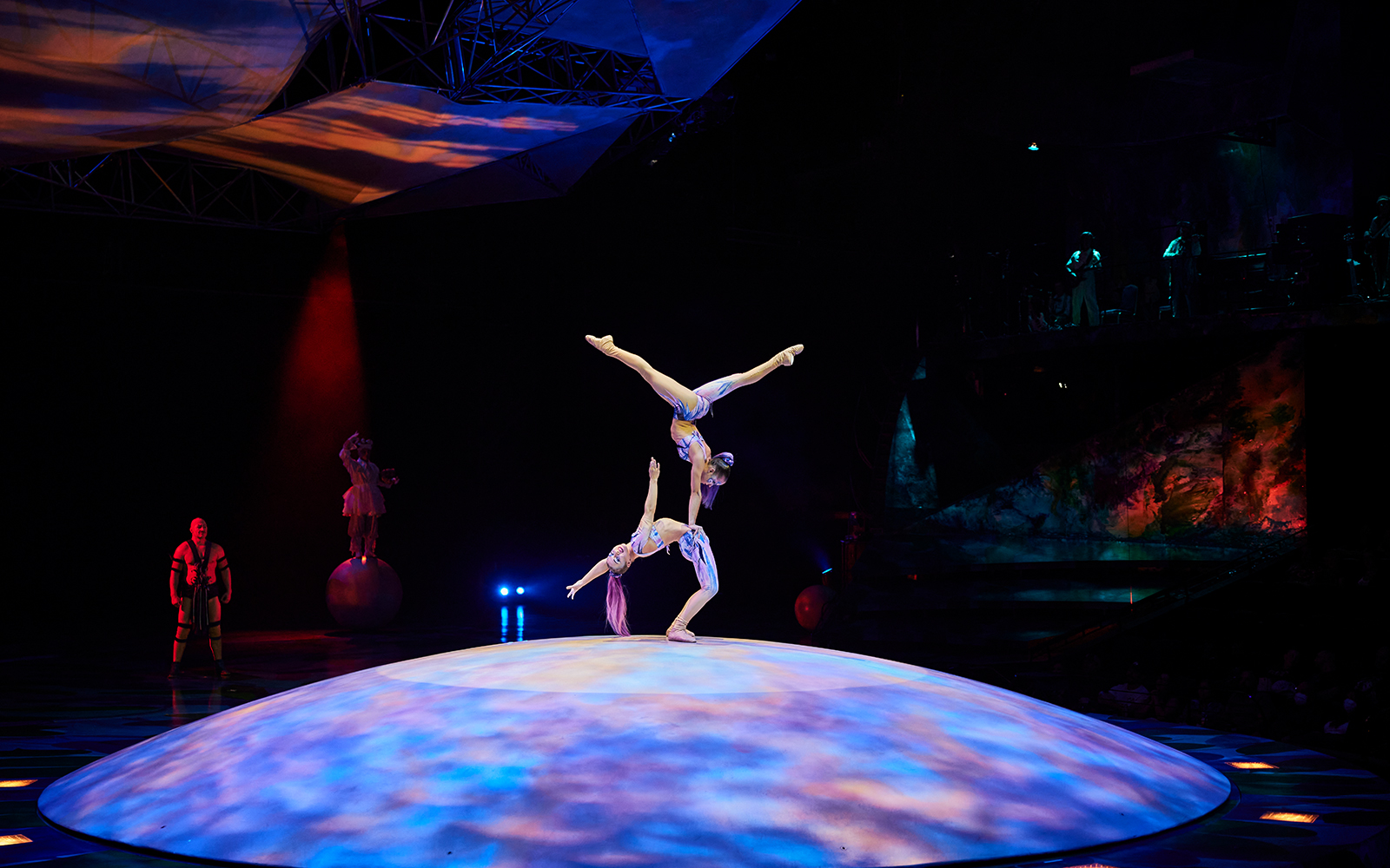 Acrobats performing a balancing act on stage during Mystère show.