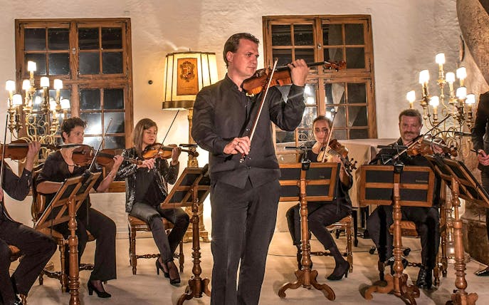 Musicians playing violins at Mozart concert in Fortress Hohensalzburg, Salzburg.