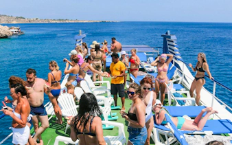 People enjoying a sunny day on a cruise ship deck during the Blue Lagoon cruise from Larnaca.