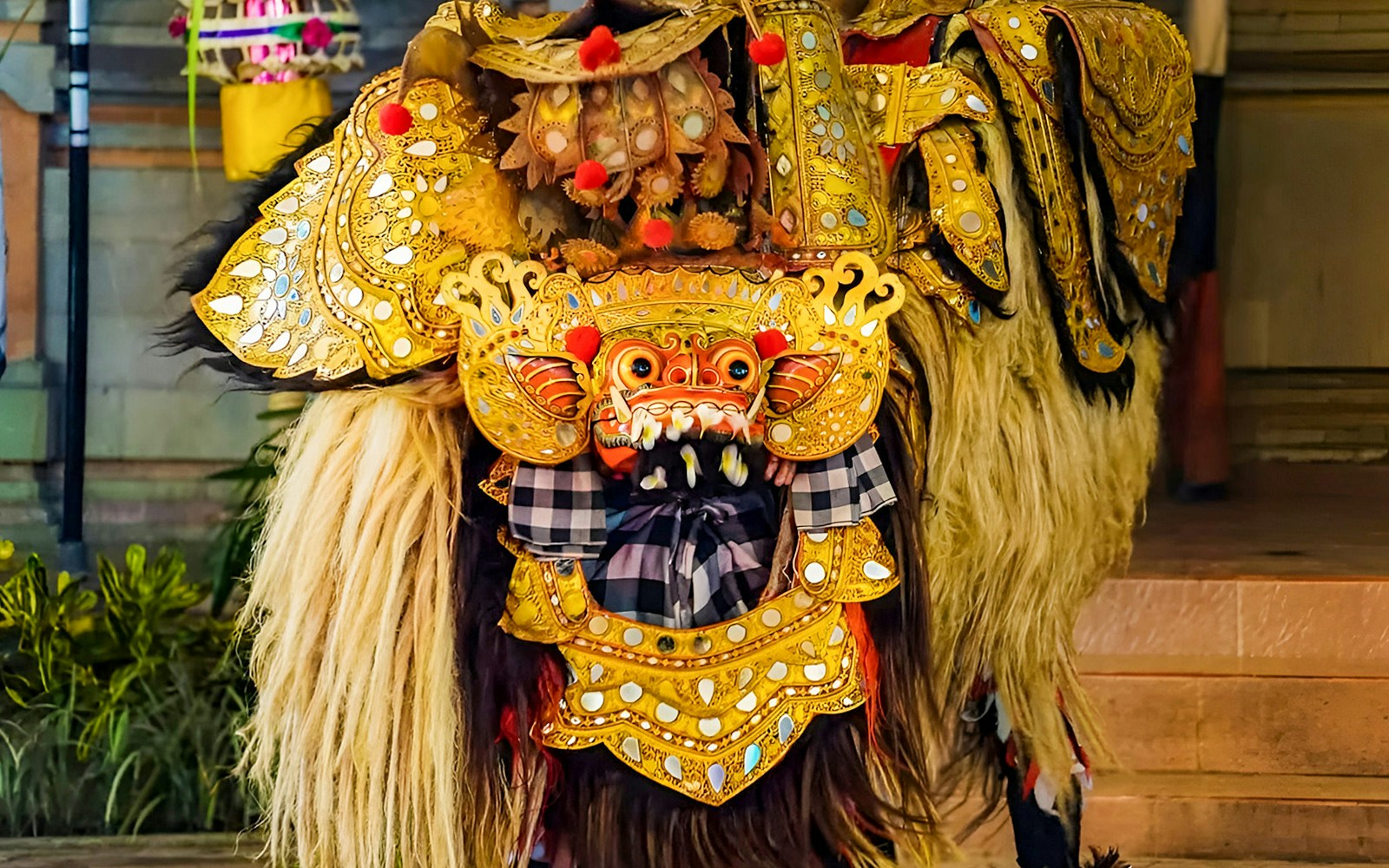 Ubud Kecak dance costume with intricate gold detailing and traditional mask.