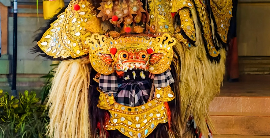 Ubud Kecak dance costume with intricate gold detailing and traditional mask.