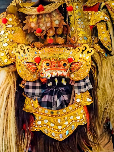 Ubud Kecak dance costume with intricate gold detailing and traditional mask.