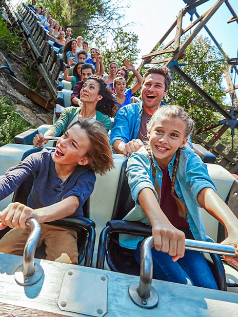 Visitors enjoying a roller coaster ride at PortAventura.
