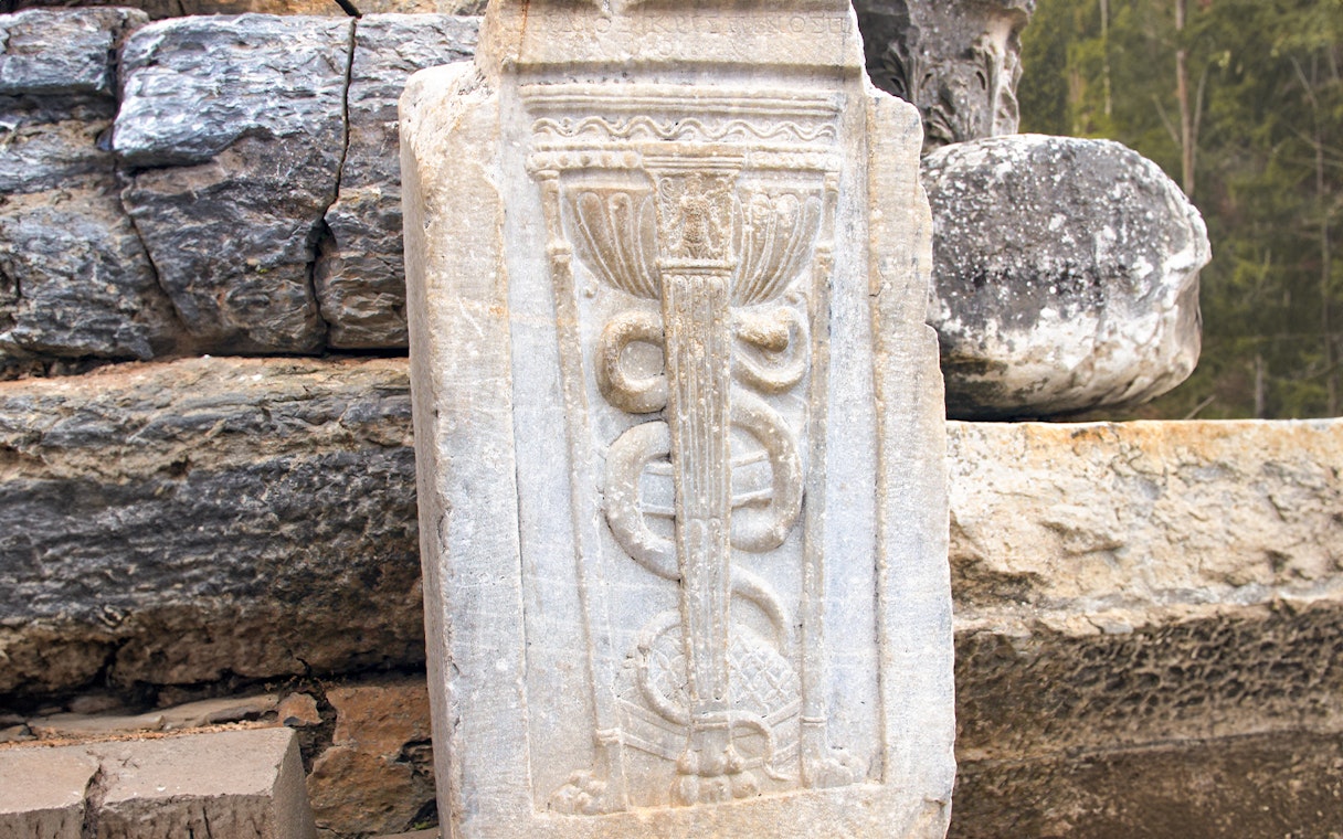 Ancient stone carving with serpent motif in Ephesus, Turkey.