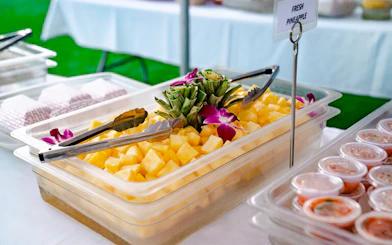Fresh pineapple display at Mauka Warriors Luau buffet.