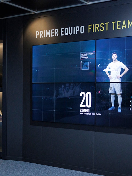 Trophy display at Santiago Bernabéu Stadium museum, featuring football awards and memorabilia.